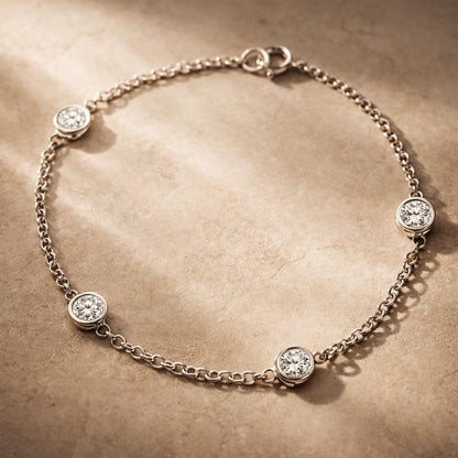 Silver bracelet with diamond accents on a textured beige surface