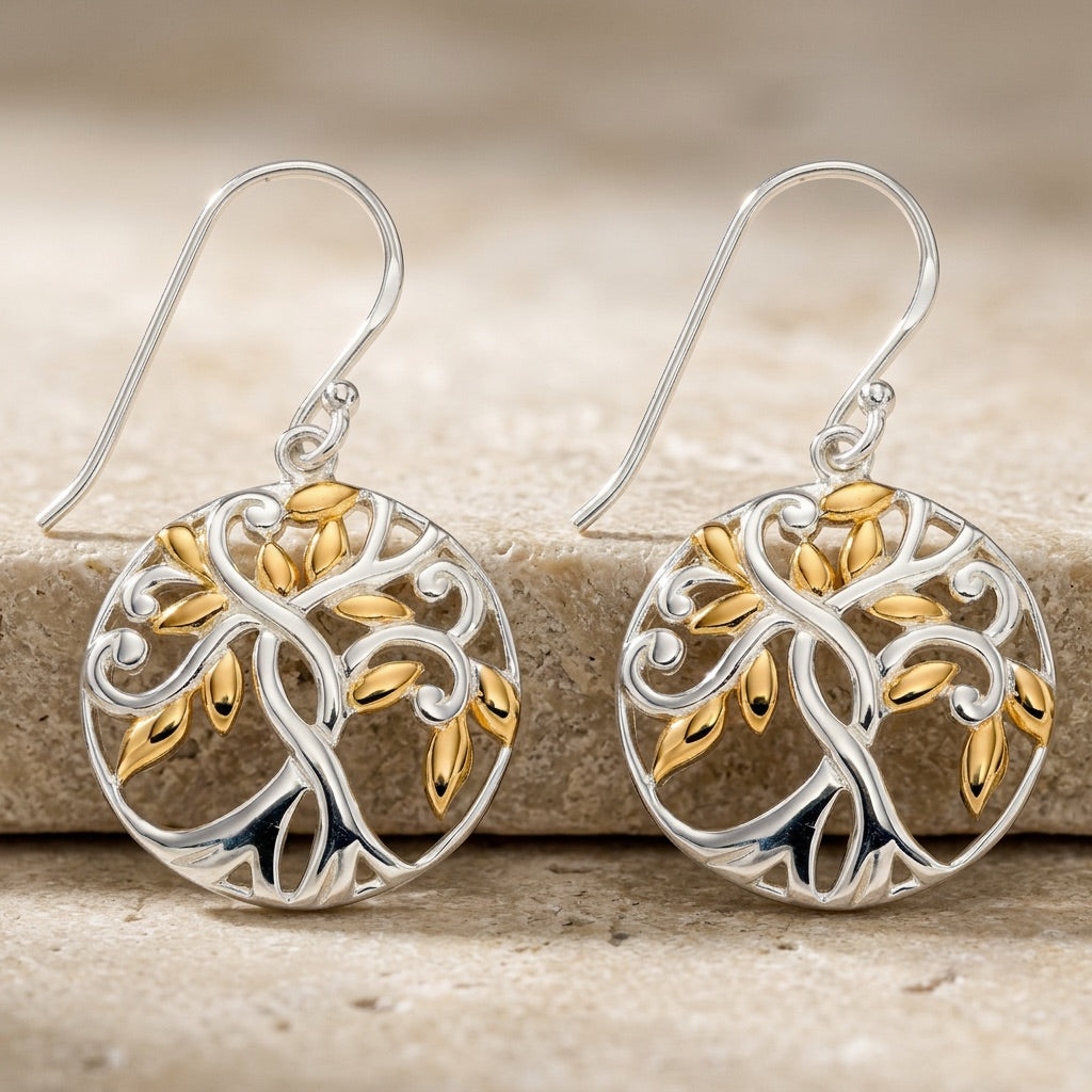 Pair of Tree of Life Gold plate Earrings  on a stone surface