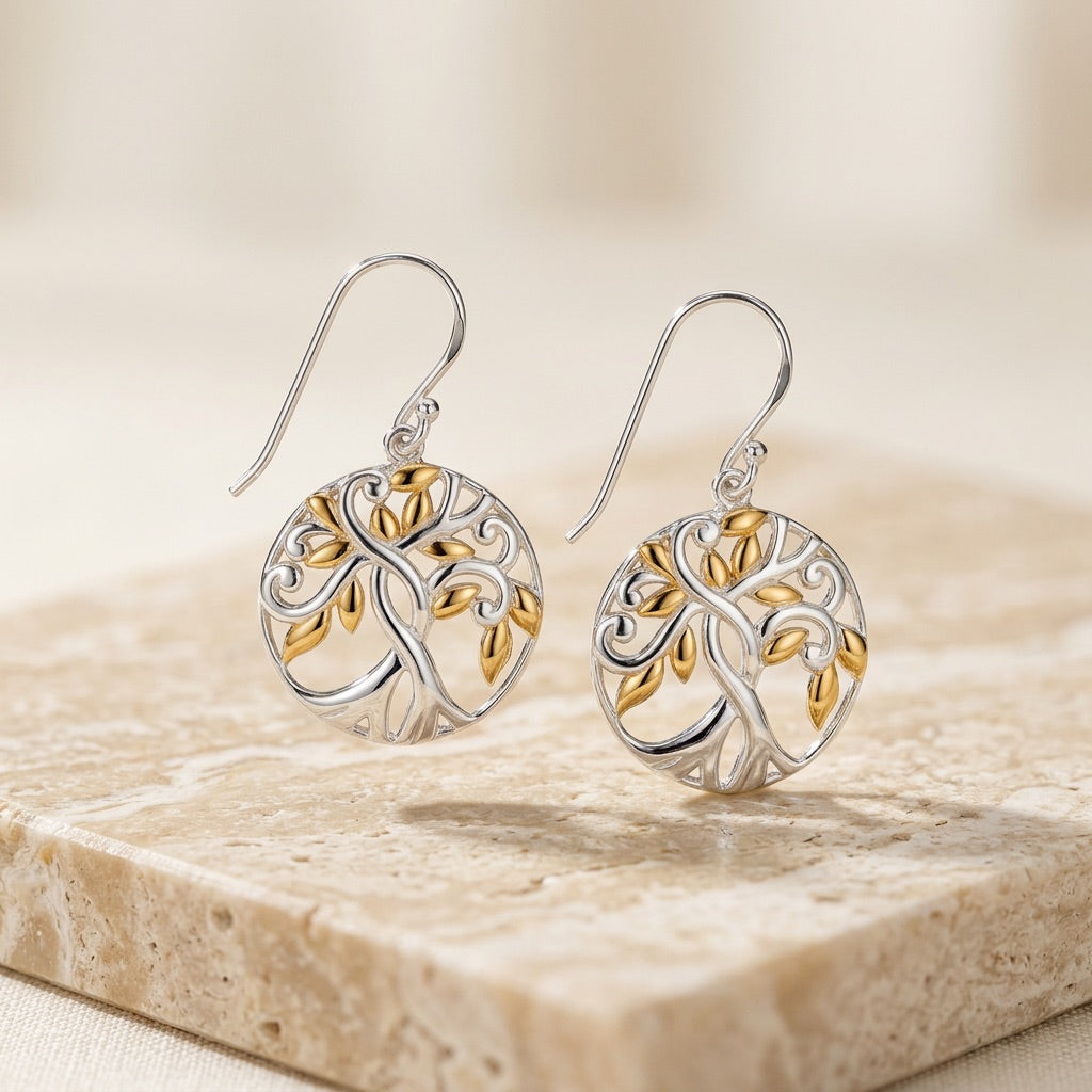 Pair of Tree of Life Gold plate Earrings  on a stone surface