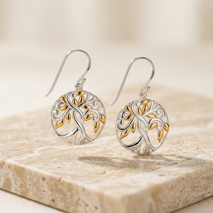 Pair of Tree of Life Gold plate Earrings  on a stone surface
