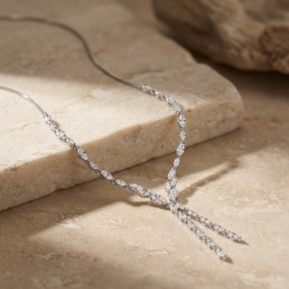 Cubic Zirconia Marquise Statement Necklace on a beige stone surface