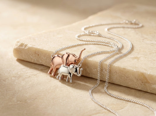 Necklace with elephant pendants on a beige surface