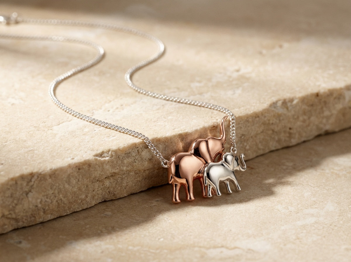 Necklace with elephant pendants on a stone surface