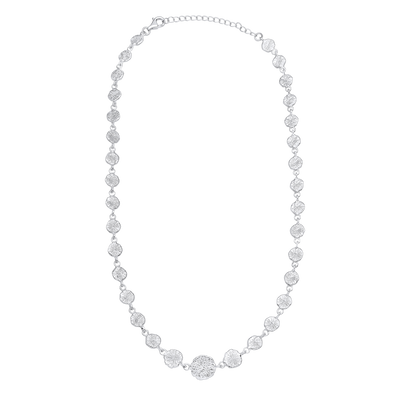 Silver necklace with round pendants on a white background