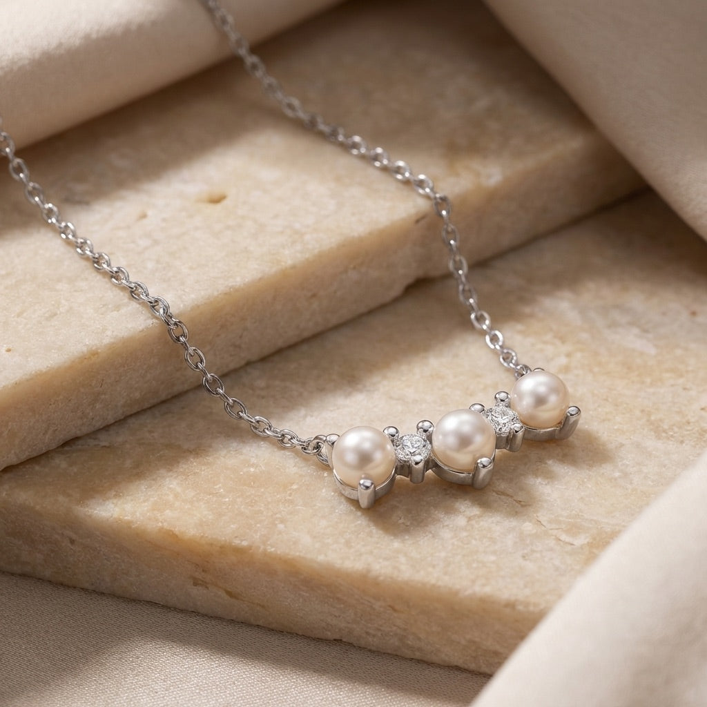 Curved Freshwater Pearl and Cubic Zirconia Bar Necklace on beige stone surface