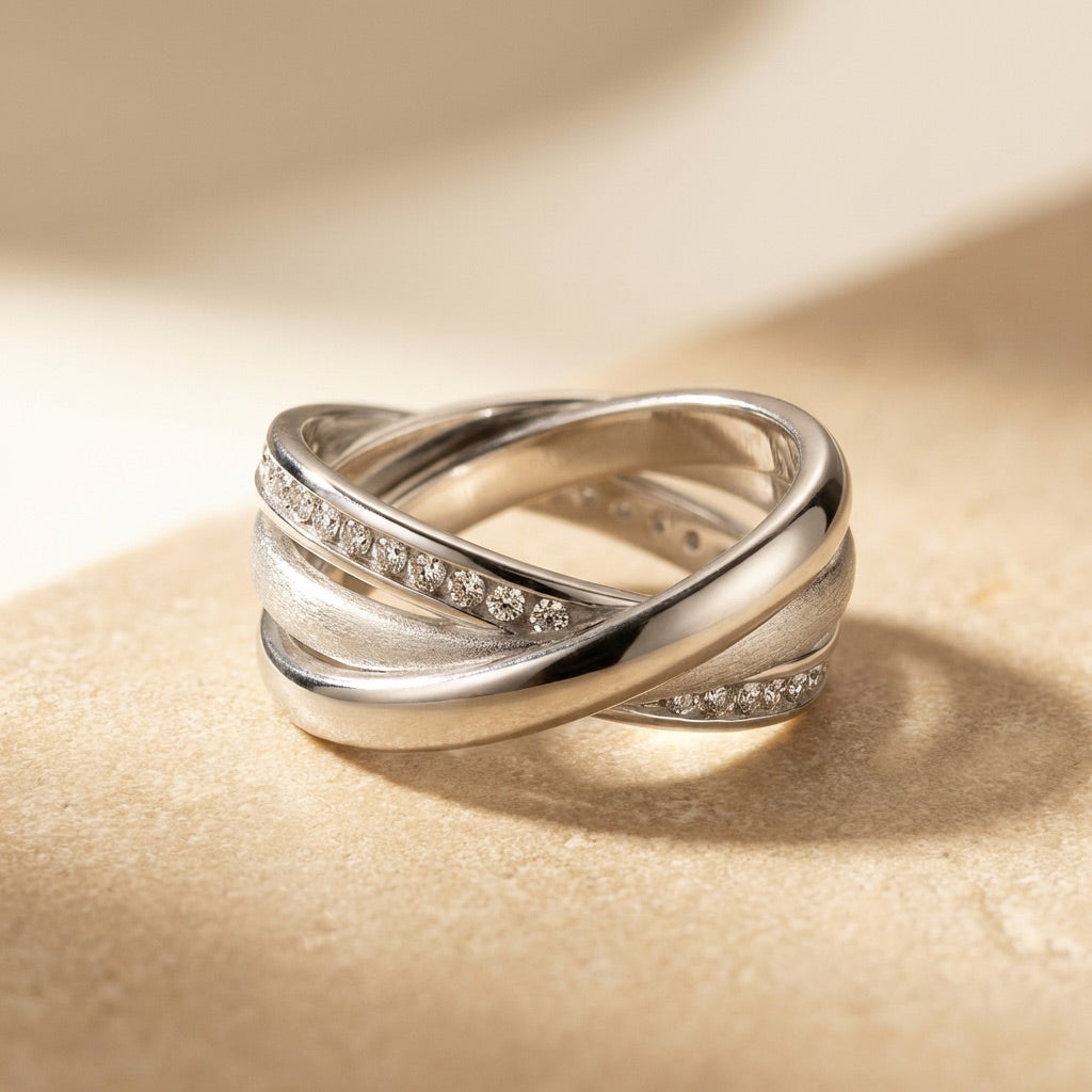 Silver ring with diamond accents on a beige background