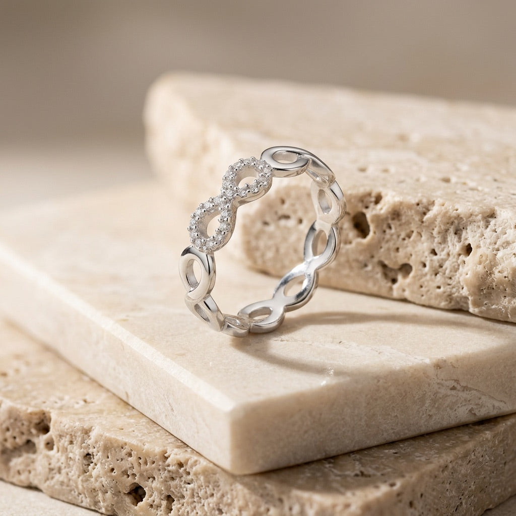 Silver ring with diamond accents on a stone surface