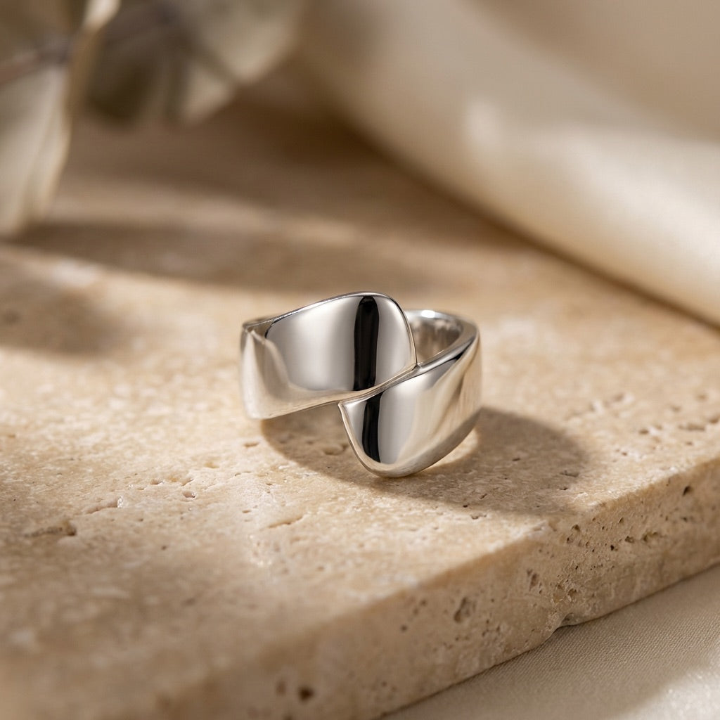 Silver Wrap Ring  on a textured beige surface