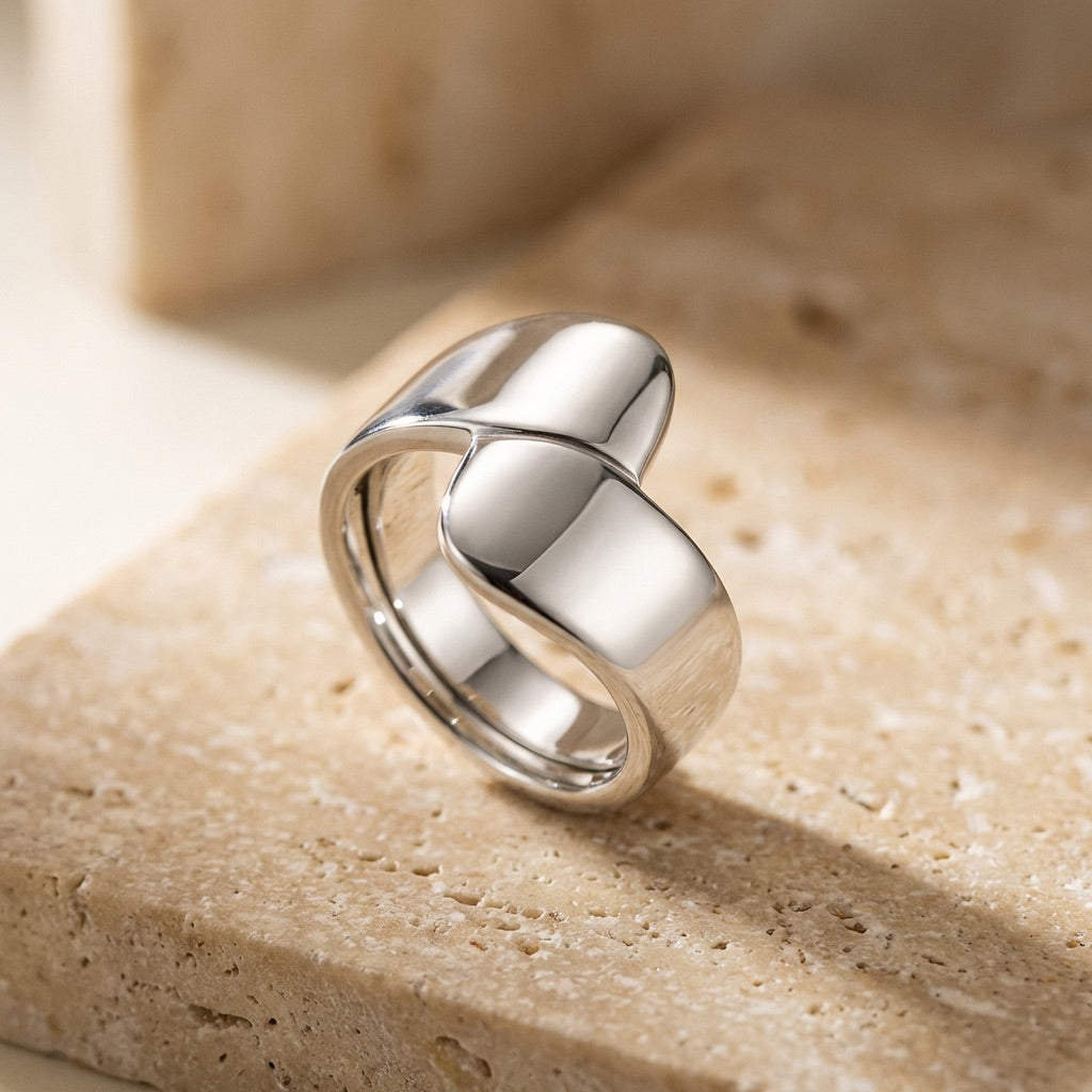 Silver Wrap Ring on a beige stone surface
