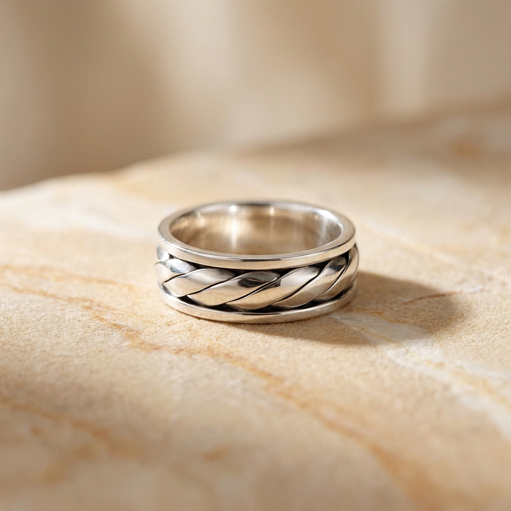 Twist Design Spinner Ring on beige tile background
