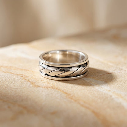 Twist Design Spinner Ring on beige tile background