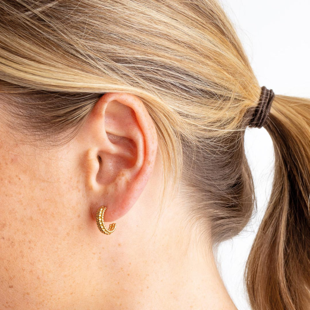Gold Plate 13mm Triple Beaded Stud Hoop Earrings . worn by a person with blonde hair tied back.